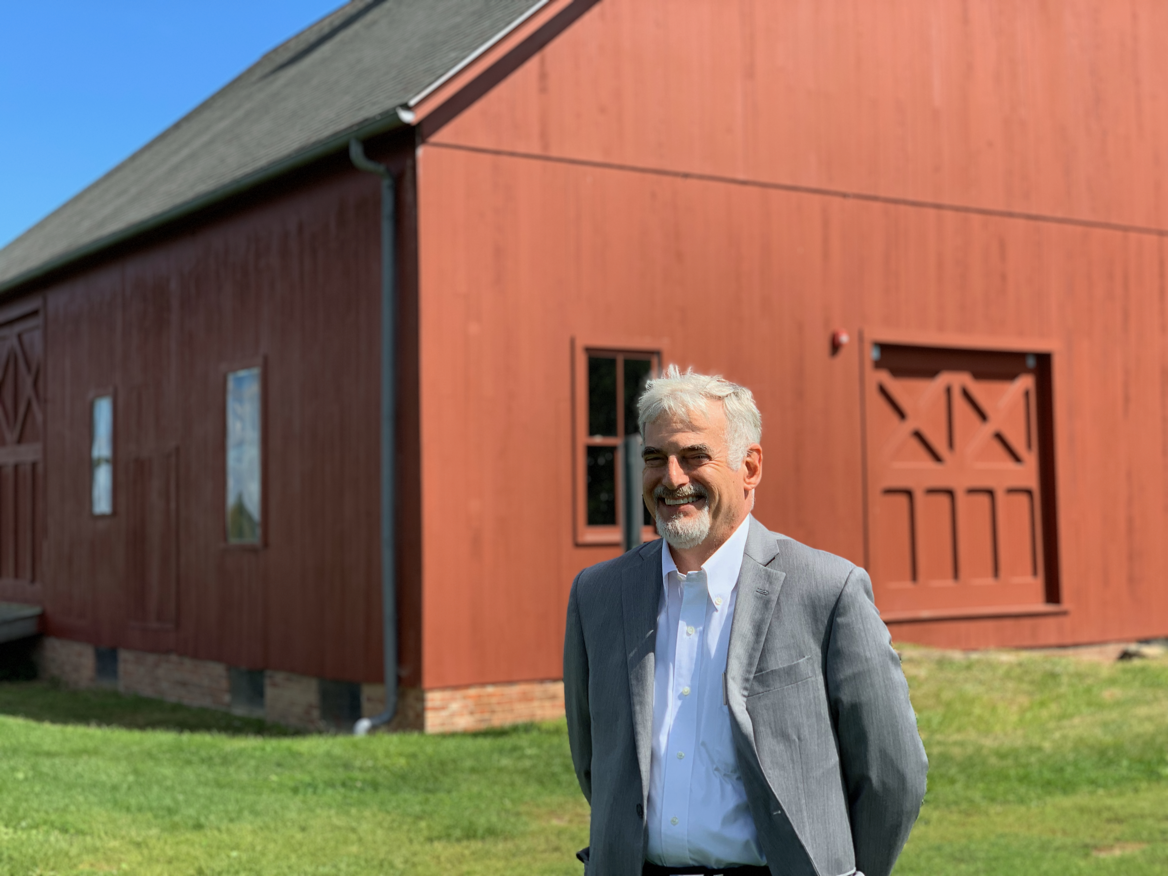 P&Z chair Adam Teller with Heritage Farm barn in background